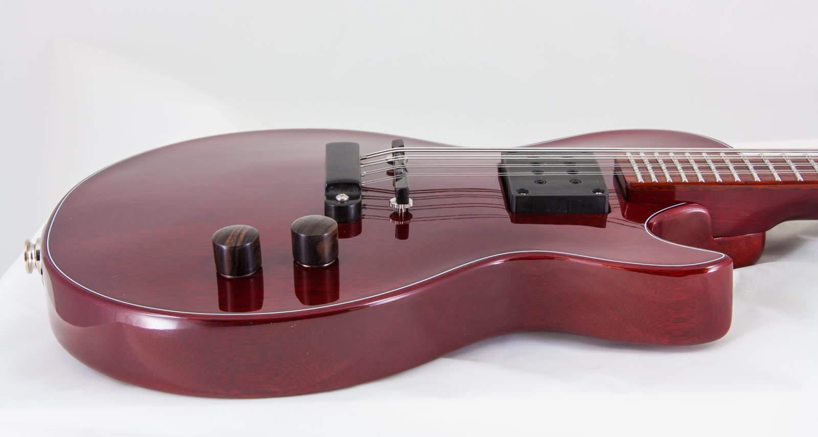 Electric mandolin — top, red lacquer solidbody, low angle toward headstock