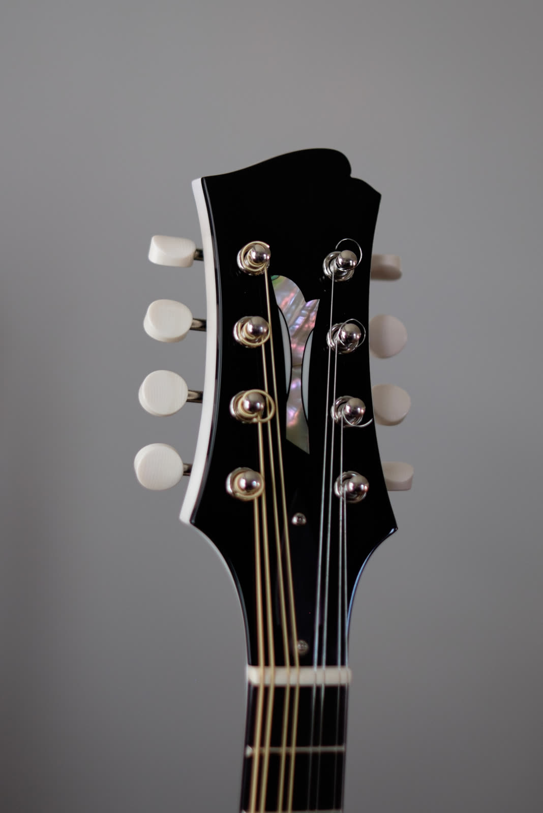 A-model mandolin — peghead, mother-of-pearl inlay, white-bound edges