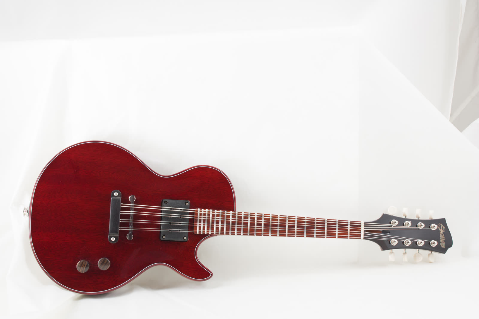 Electric mandolin — front, red lacquer solidbody, resting diagonal on white