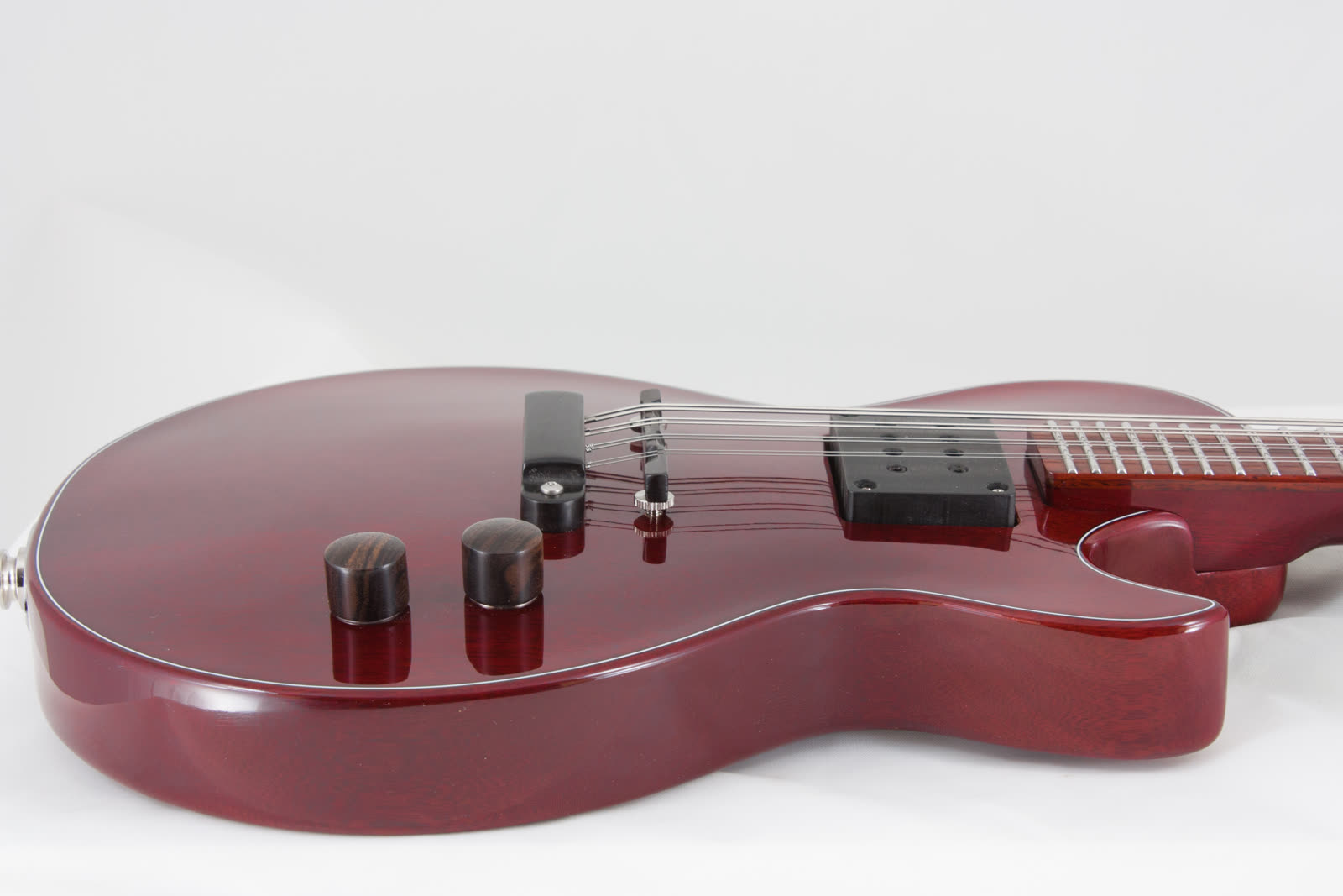 Electric mandolin — tailpiece, red lacquer top, low angle