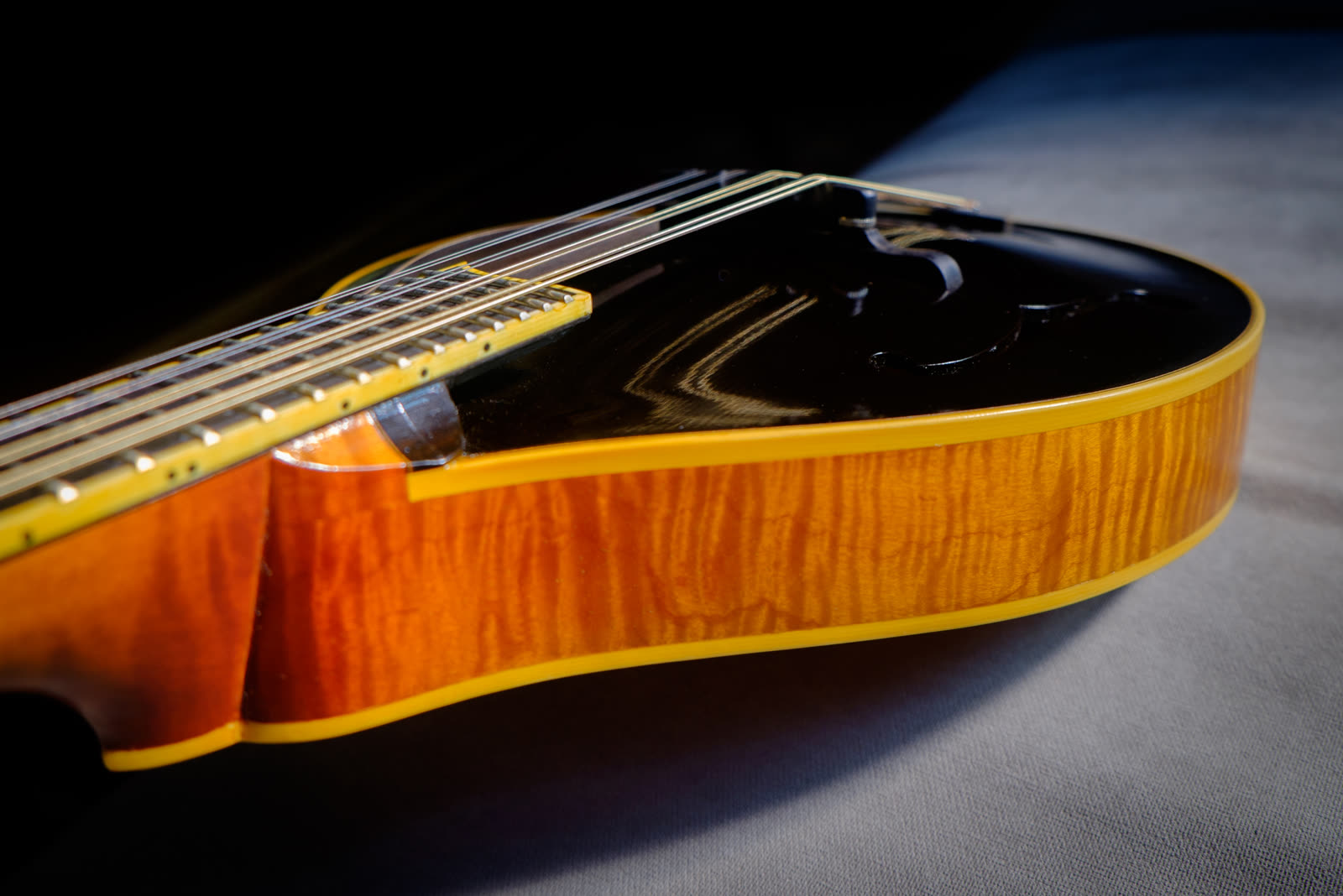 A-model mandolin, side, curly maple, black top